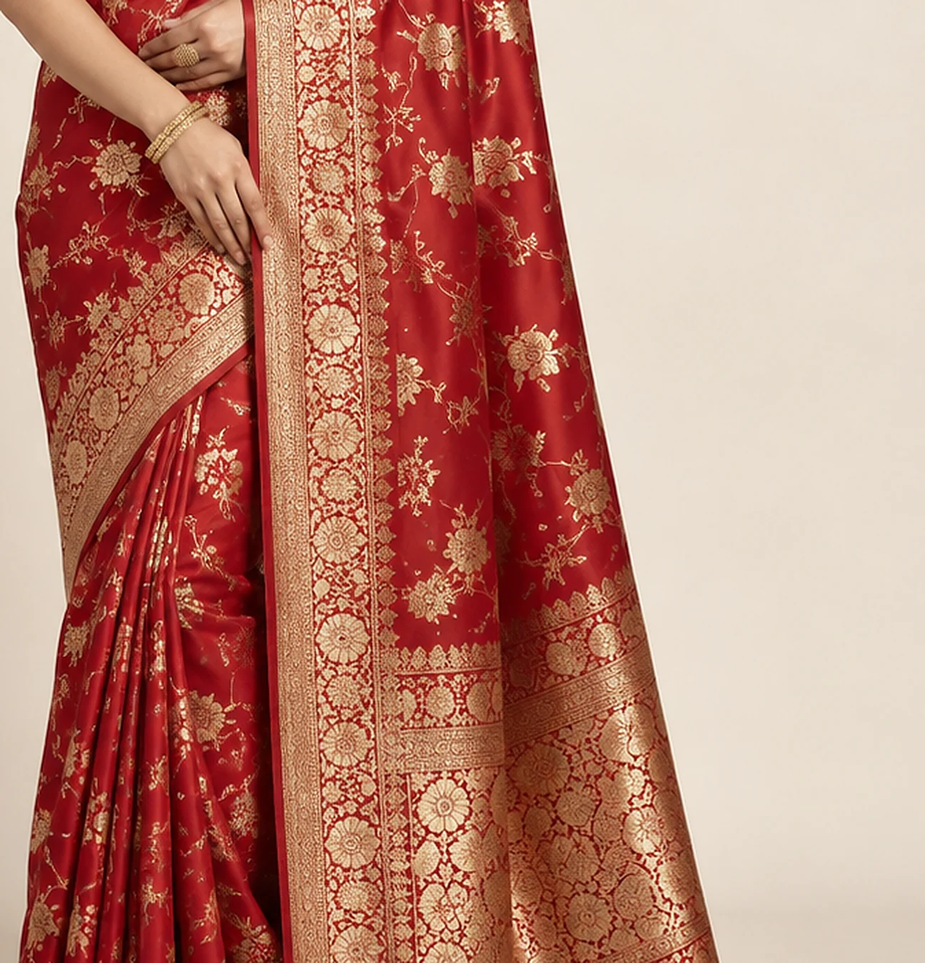Red and gold embroidered saree detail