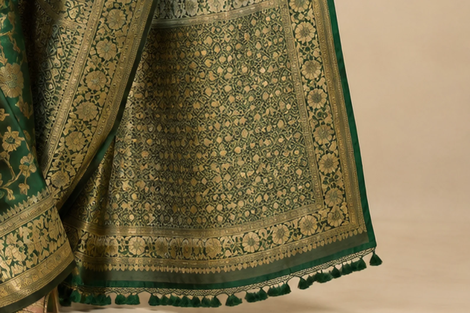 Close-up of a green silk saree with gold zari paisley woven into the pallu